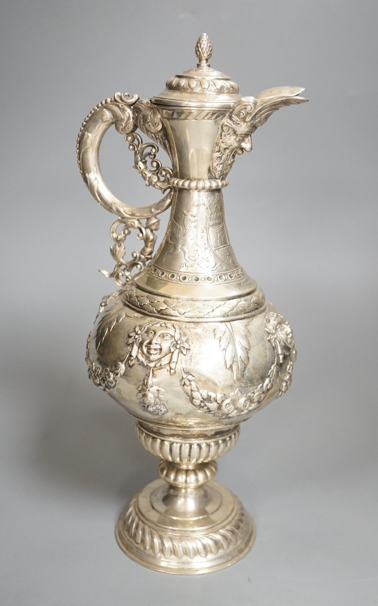 A 19th century Continental white metal wine ewer, embossed with swags and masks, height 29.9cm, 16.5oz.